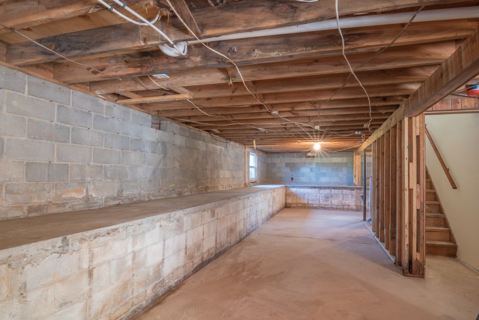 Damp crawl space beneath a house foundation